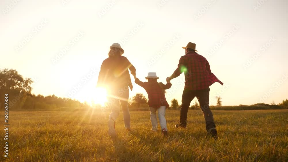 happy family children kid run in the park at sunset. people in the park concept mom dad daughter and son joyful run. happy family and little baby child fun summer kid dream silhouette concept happy family children kid run in the park at sunset. people in the park concept mom dad daughter and son joyful run. happy family and little baby child fun summer kid dream silhouette concept