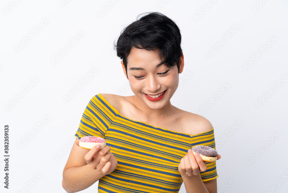 Young Asian girl holding donuts with happy expression Young Asian girl holding donuts with happy expression