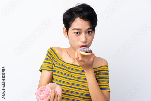 Young Asian girl holding a donut
