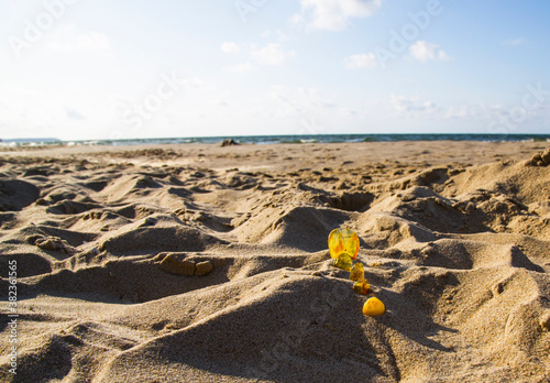 Amber in the sand against the background of sea waves. photo