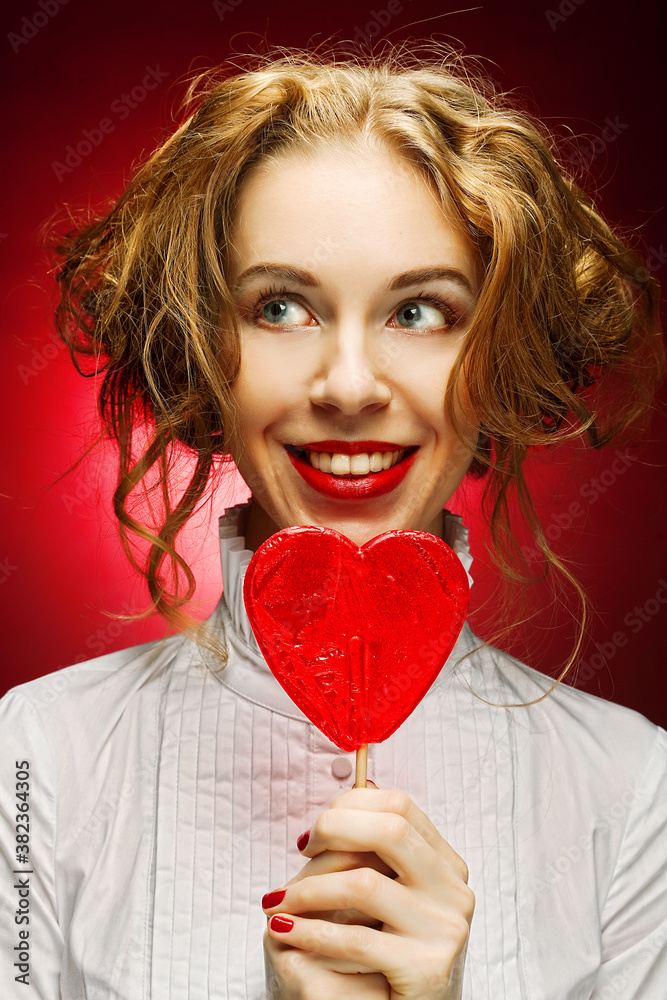 woman with heart caramel over red background woman with heart caramel over red background