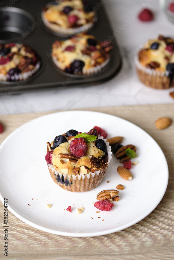 mixed berry low carb Keto Diet muffin with almond and nut. set on cafe table. mixed berry low carb Keto Diet muffin with almond and nut. set on cafe table.