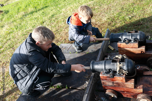 Boys load signal ancient cannons