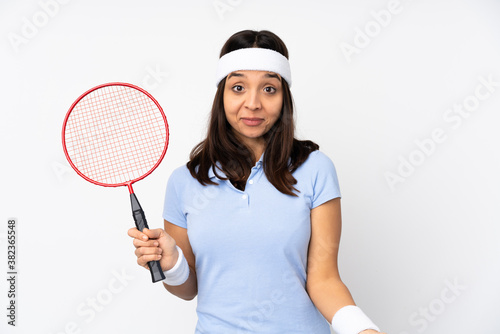 Young badminton player woman over isolated white background smiling © luismolinero