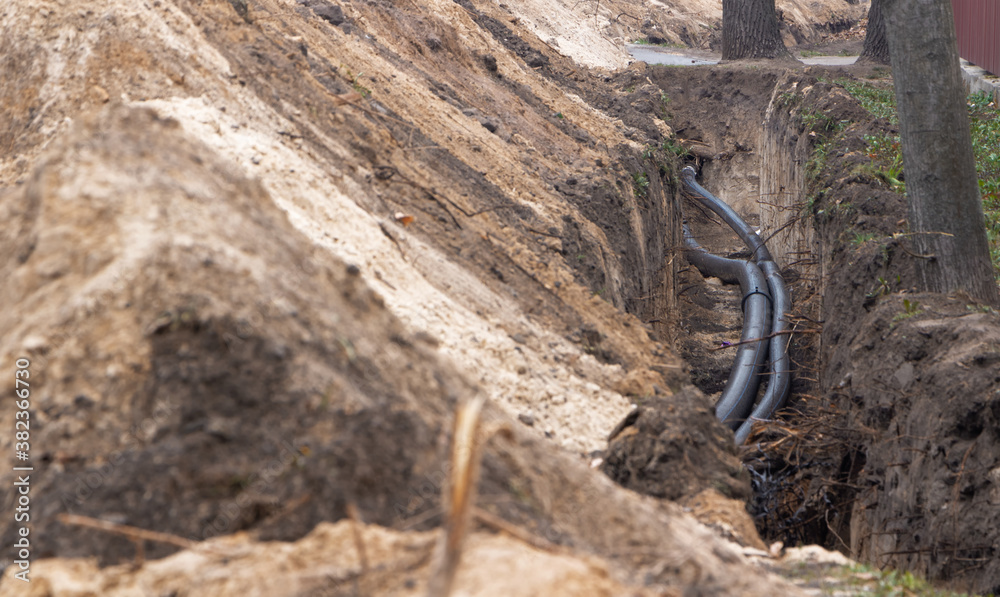 Black plastic pipes for underground water supply. PVC pipes. Sewer system repair. Black plastic pipes for underground water supply. PVC pipes. Sewer system repair.