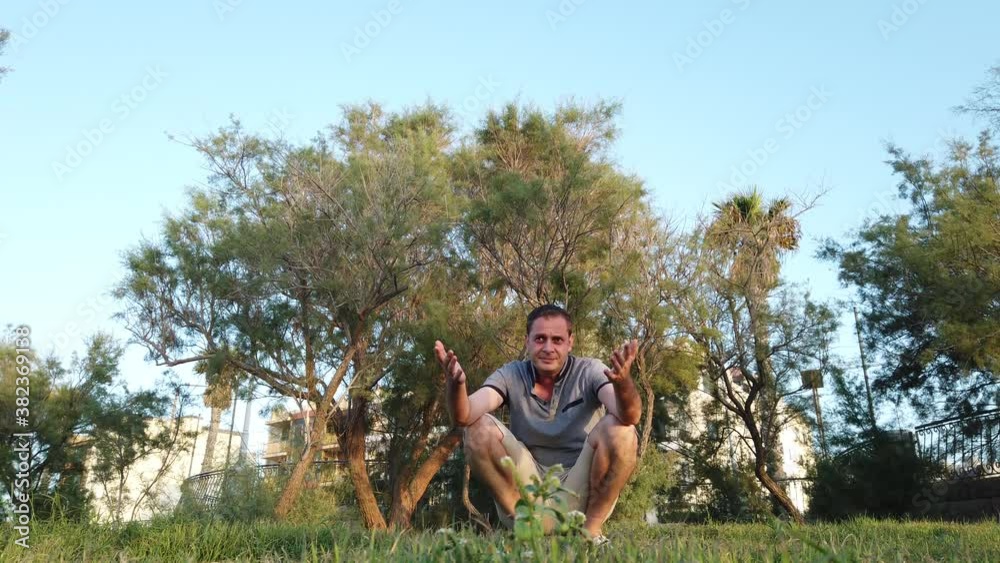 Father squats in the park and calling his kids. Boys running into the dads hug. High quality 4k footage Father squats in the park and calling his kids. Boys running into the dads hug. High quality 4k footage