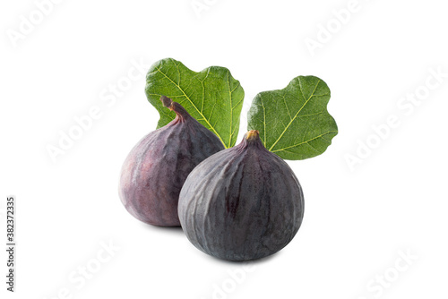 Two fresh figs with leaves isolated on white background. Clipping path