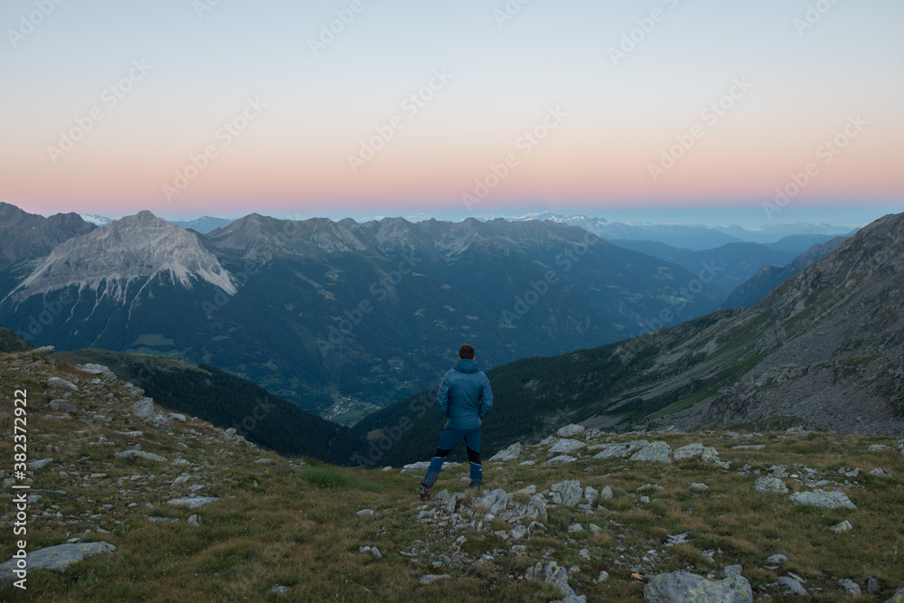 person watching the sunset in the mountains