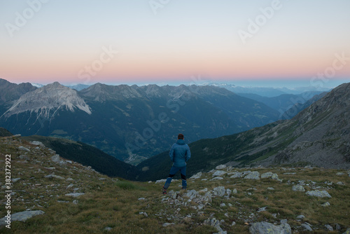 person watching the sunset in the mountains