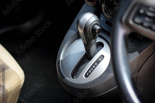automatic transmission shift selector in the car interior. Closeup a manual shift of modern car gear sifter. © Muanpare