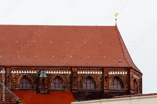 The roof of the Catheral of Schwerin, Germany. Exterior view against cloudy sky. photo