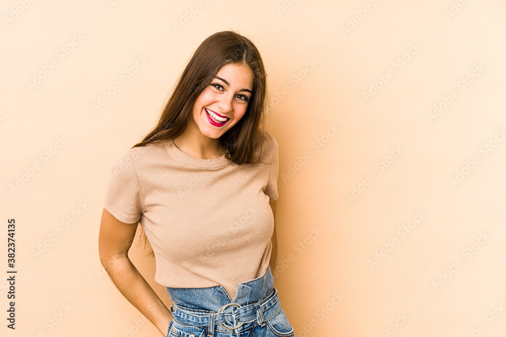 Young caucasian woman isolated en beige background happy, smiling and cheerful. Young caucasian woman isolated en beige background happy, smiling and cheerful.