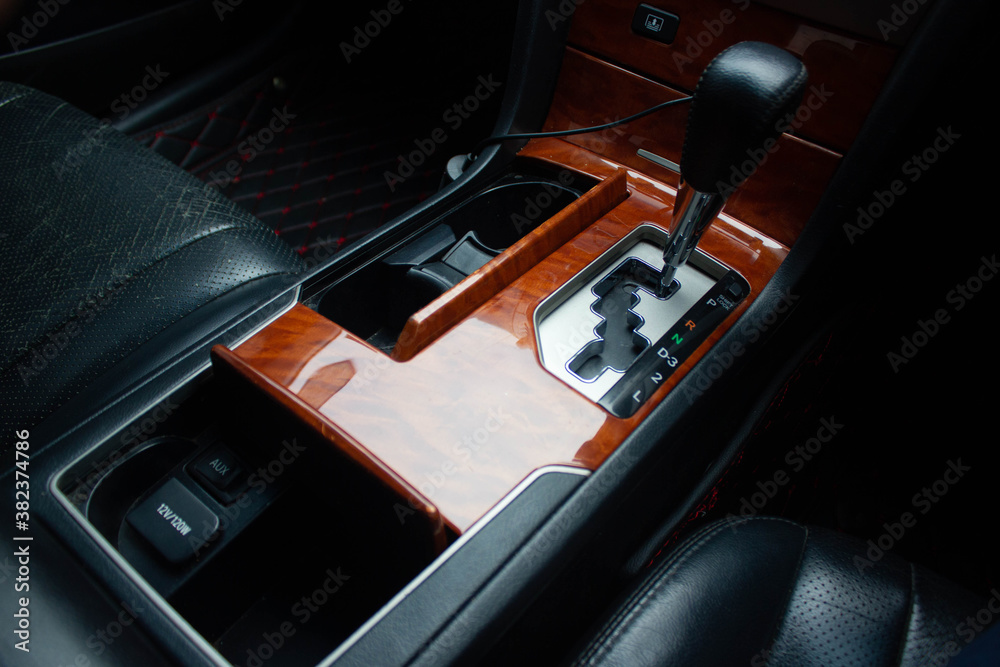 Naklejka premium automatic transmission shift selector in the car interior. Closeup a manual shift of modern car gear sifter.
