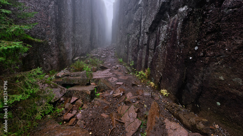 High cliffs on both sides at once leading away in foggy weather