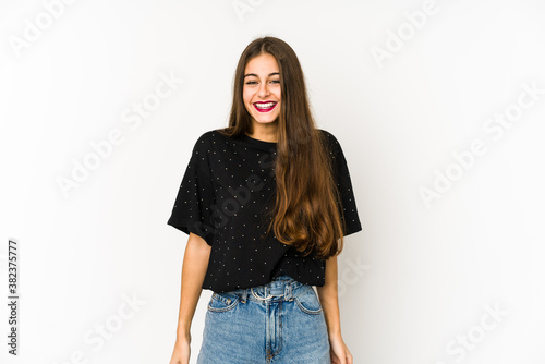 Young caucasian woman isolated on white background laughs and closes eyes, feels relaxed and happy.