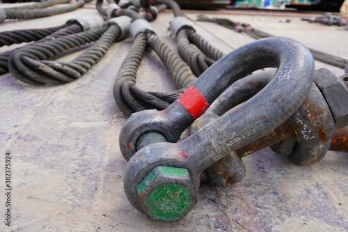 Photography Shackles and wire slings set on the ground in heavy duty industrial or oil and gas plant