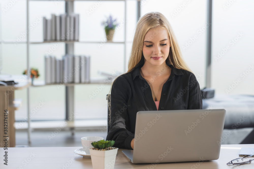 Young business woman working from home-office with morning sunshine. woman communicating in social network and searching information online. Young business woman working from home-office with morning sunshine. woman communicating in social network and searching information online.