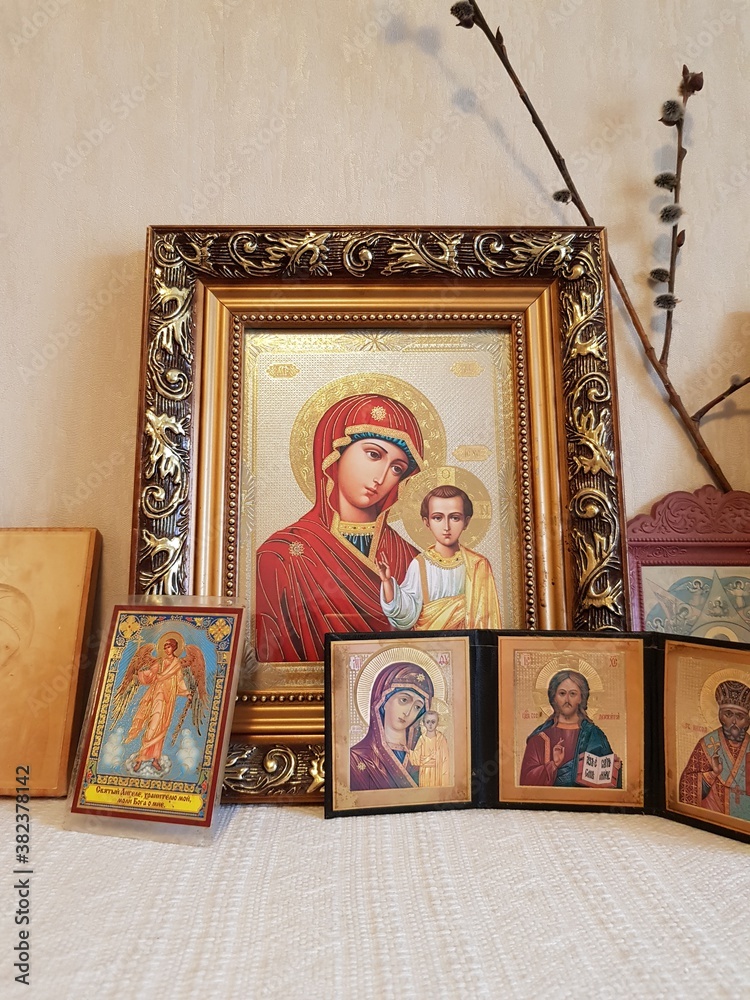 Antique Orthodox Christian icons stand on a shelf