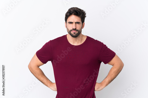 Young handsome man with beard over isolated white background angry