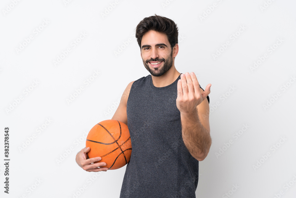 Basketball player man with beard over isolated white background inviting to come with hand. Happy that you came