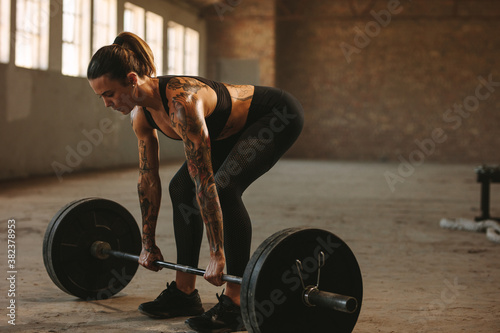 Fitness female doing weightlifting workout photo