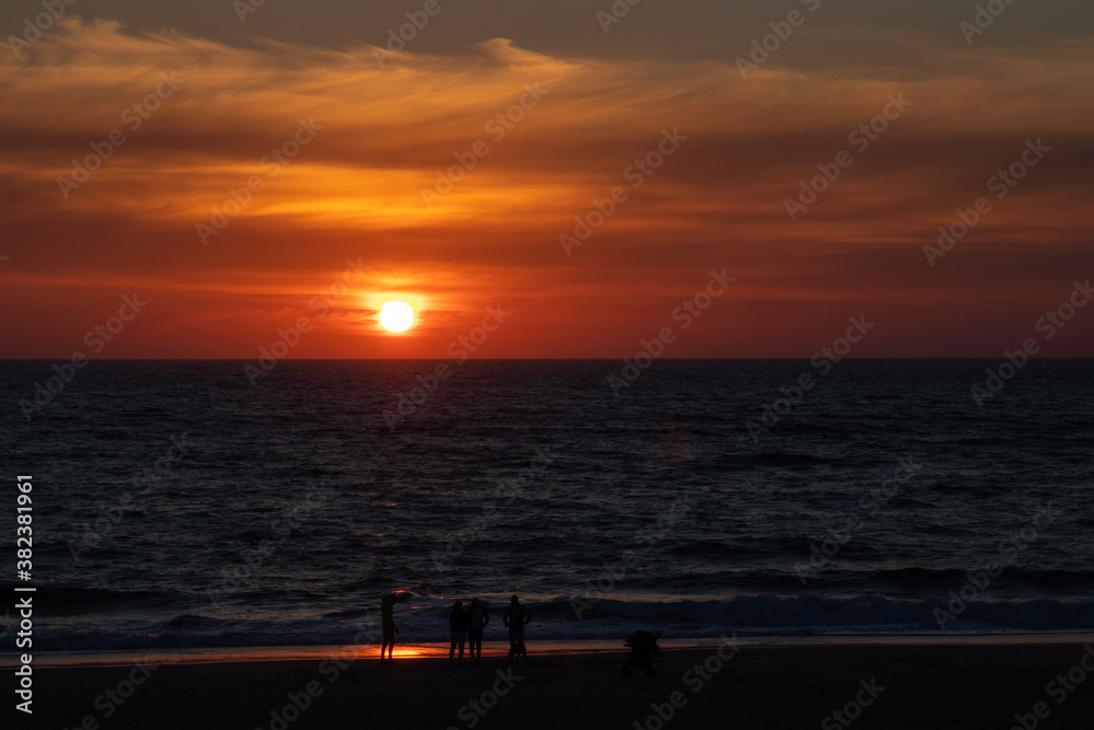 children enjoying the sunset on the beach, Portugal