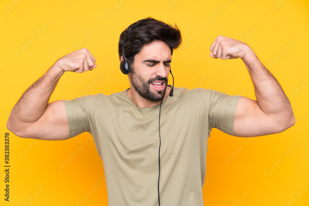 Telemarketer man working with a headset over isolated yellow background celebrating a victory Telemarketer man working with a headset over isolated yellow background celebrating a victory