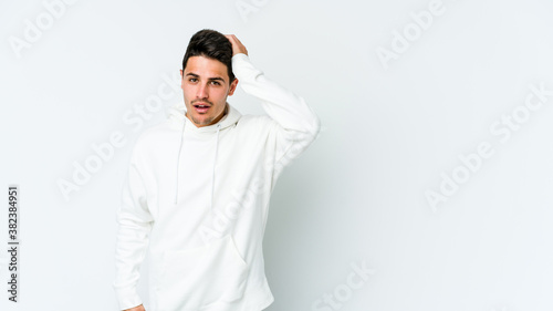 Young caucasian man isolated on white background being shocked, she has remembered important meeting.