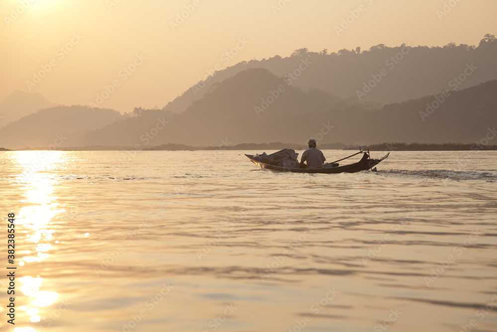Nam Ou River, boats and landscape with mountains and riverside villages sunrise