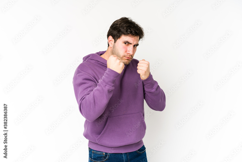 Young man isolated on white background showing fist to camera, aggressive facial expression. Young man isolated on white background showing fist to camera, aggressive facial expression.