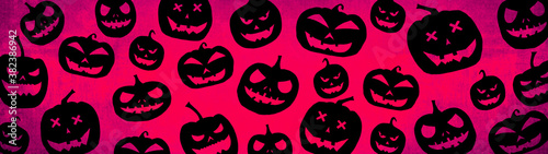 HALLOWEEN symbol background banner wide panoramic panorama template design -Top view Silhouette of scary carved luminous cartoon pumpkins isolated on dark pink magenta red texture