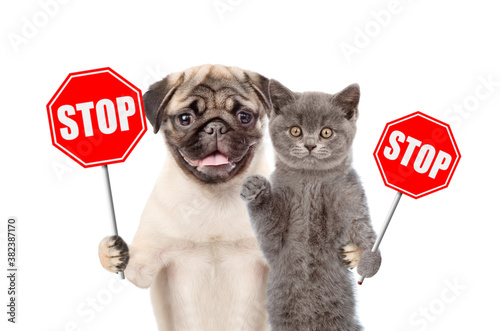 Obraz na plátne Cat and dog hold stop signs. Isolated on white background
