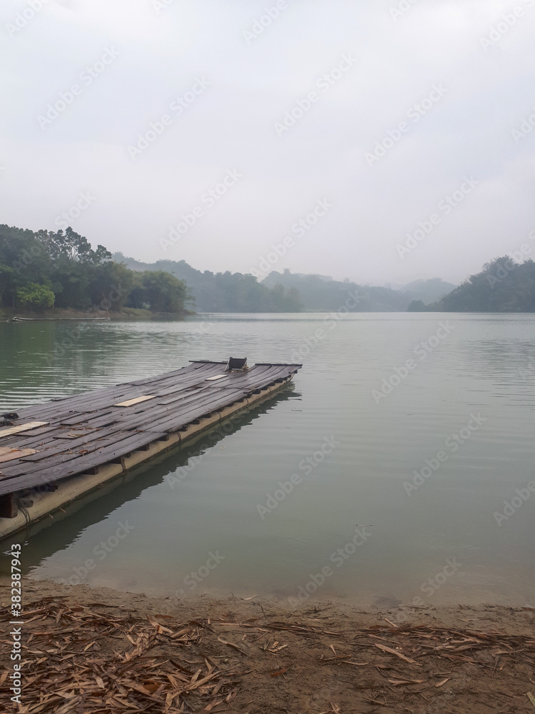 There is a small boat by the lake on a cloudy day