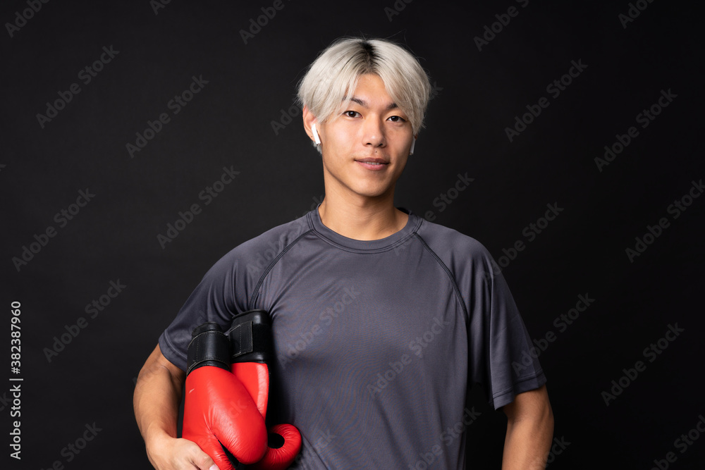 Young asian sport man over isolated black background Young asian sport man over isolated black background