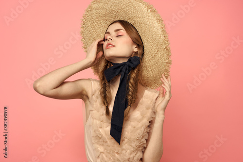 Beautiful woman in hat and in black dress ribbon portrait pink background model