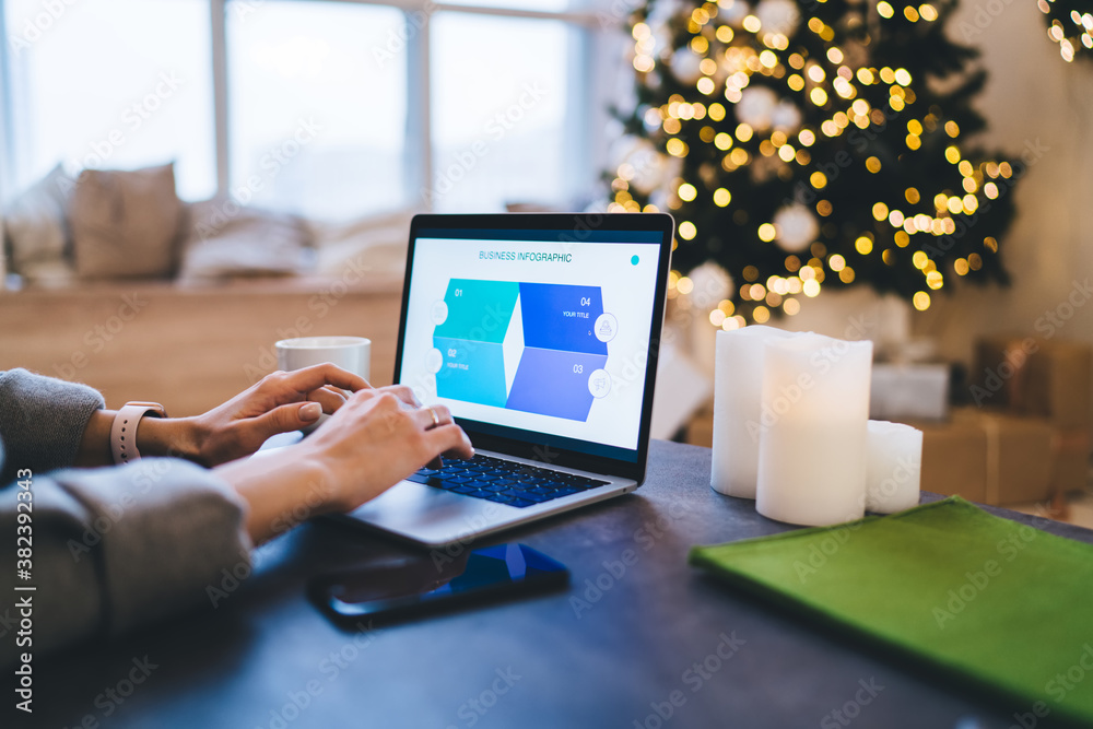 Crop freelance worker using laptop during winter break Crop freelance worker using laptop during winter break
