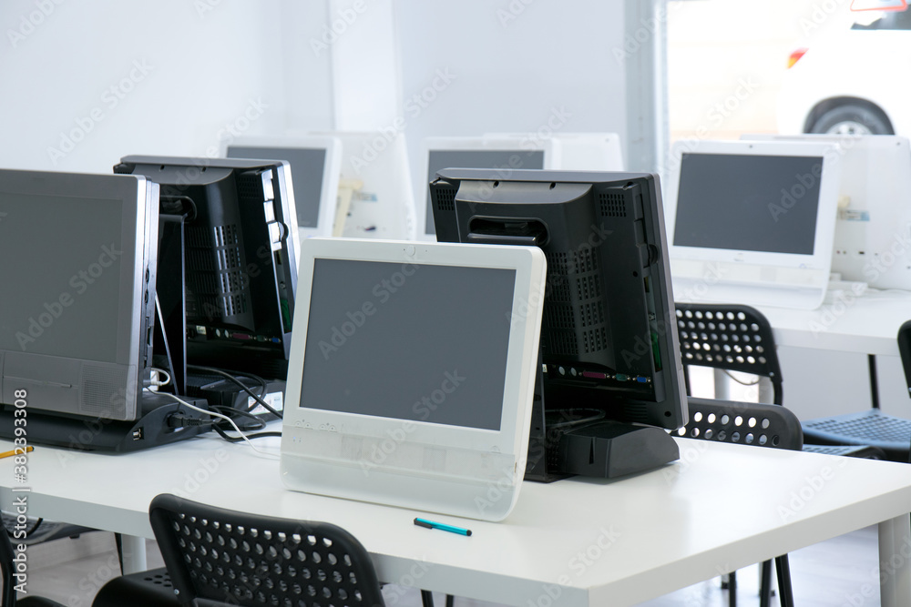 Empty classroom with several computers on table. Online webinar course. Empty classroom with several computers on table. Online webinar course.
