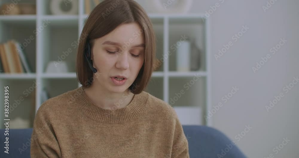 woman is communicating online, using laptop with internet and headphones with microphone, online chat, tech support woman is communicating online, using laptop with internet and headphones with microphone, online chat, tech support