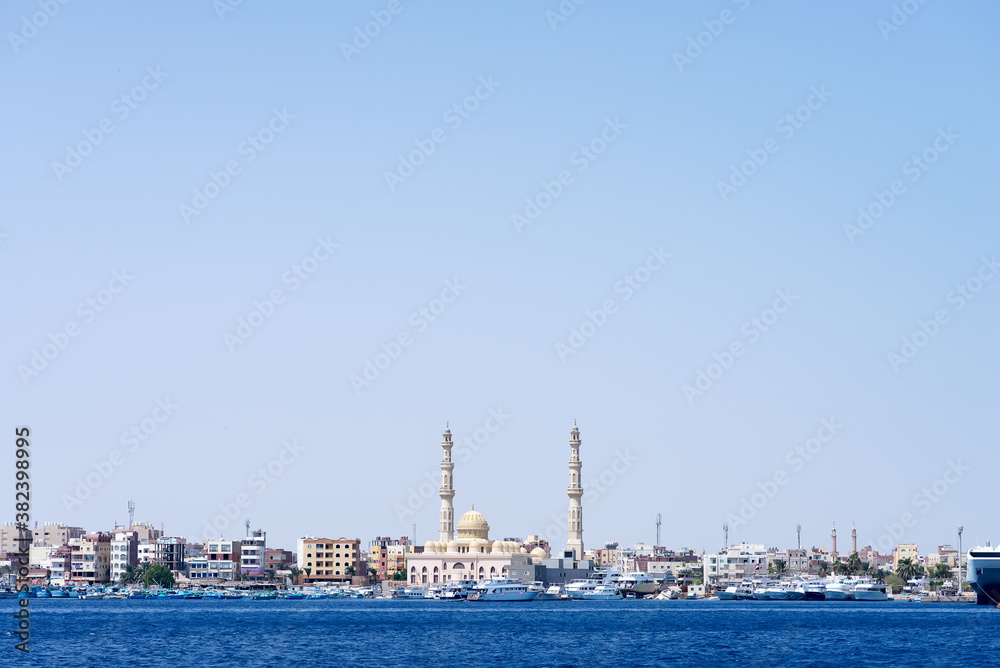 Sea bay with parked speed boats near Hurghada Mosque.