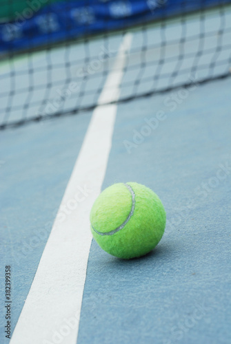 Tennis ball on concrete blue field with white line © yoki5270