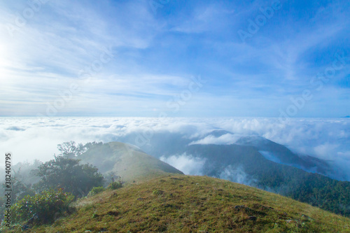 mountain hill with grass field with sea of fog or white clouds at "Doi MonJong" Chiangmai, Thailand, Asia.
