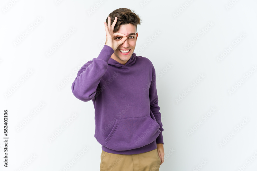 Young caucasian man isolated on white background excited keeping ok gesture on eye. Young caucasian man isolated on white background excited keeping ok gesture on eye.