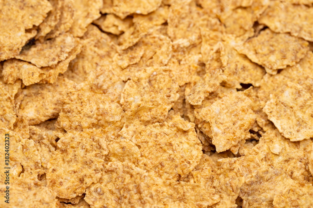 Corn-flakes background and texture, cornflake cereal box for morning breakfast. Macro shot. Selective focus. Corn-flakes background and texture, cornflake cereal box for morning breakfast. Macro shot. Selective focus.