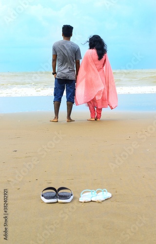 Young couple spending time together on the beach. Romantic newlyweds couple on beach. Cox's Bazar/ 2020. photo