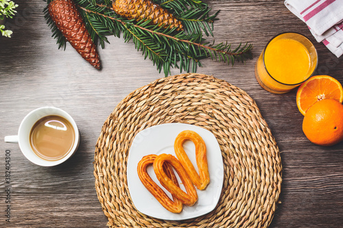 Winter Christmas breakfast with orange juice, coffee, chocolate, milk and pinecones.