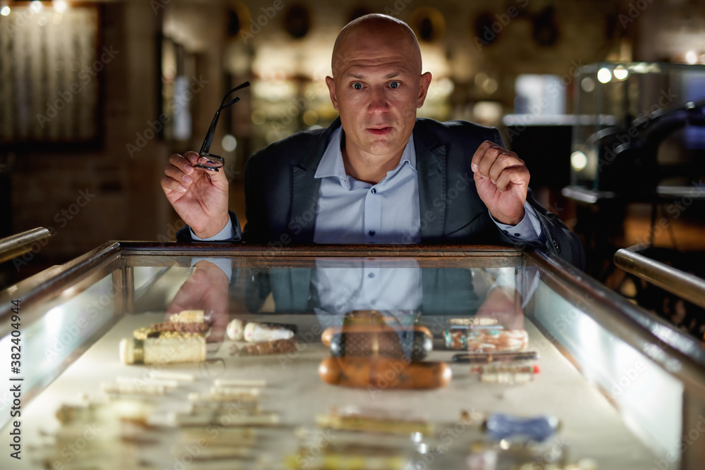 Man exploring medieval expositions in museum Man exploring medieval expositions in museum