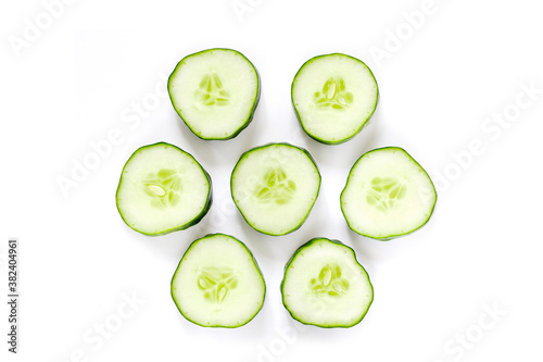 top view of fresh cucumber cut into circles isolated on a white background.