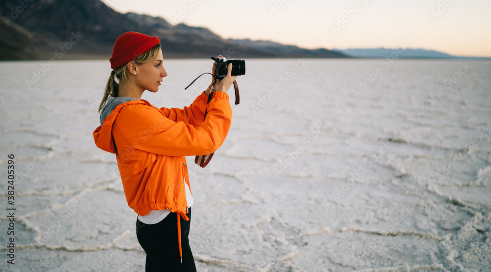 Focused woman photographing Badwater Basin