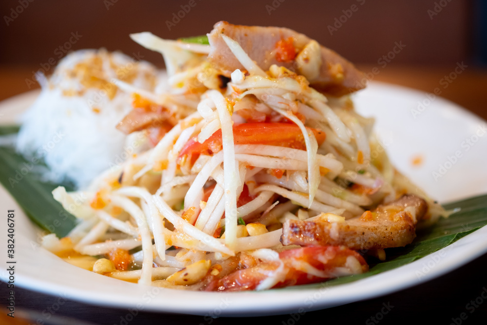 Thai spicy green papaya salad mix grilled pork neck served with rice vermicelli Thai spicy green papaya salad mix grilled pork neck served with rice vermicelli