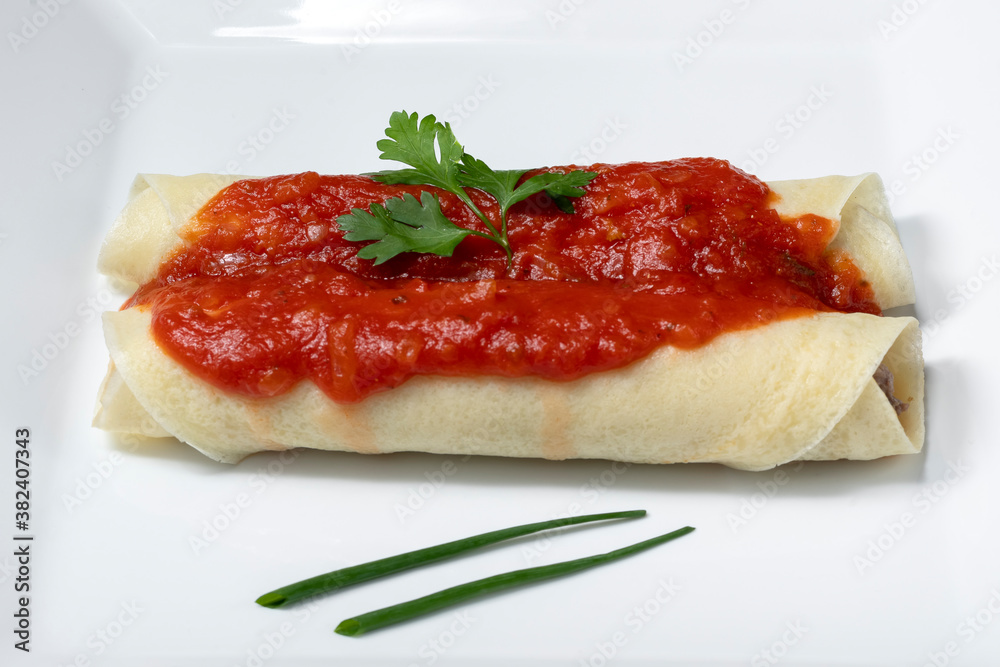 beef pancake with red sauce and parmesan cheese on a white plate beef pancake with red sauce and parmesan cheese on a white plate